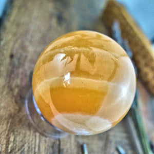 Swirls of Orange Calcite Sphere Carving - Earth Family Crystals